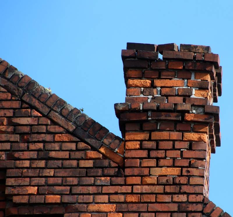 Signs Your Chicago Home Needs a Chimney Inspection Damaged chimney on an Chicago home showing cracks and missing mortar
